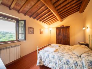 a bedroom with a bed and a large window at Apartment Raffaello by Interhome in Montaione