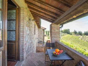 a table on a balcony with a bowl of fruit at Apartment Raffaello by Interhome in Montaione +28 photos