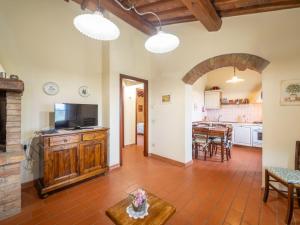 a living room with a television and a table at Apartment Raffaello by Interhome in Montaione