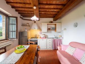a kitchen and dining room with a wooden table at Apartment Giotto by Interhome in Montaione +21 photos