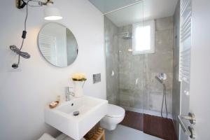 a white bathroom with a sink and a shower at Sparrow Sintra Nest in Sintra