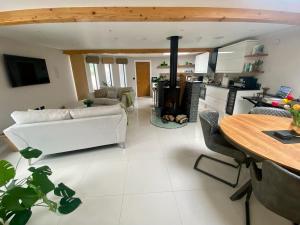 a living room with a white couch and a table at The Shutter House in Compton
