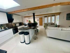 a kitchen and living room with a couch and a table at The Shutter House in Compton