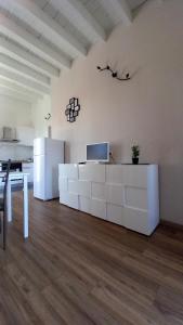 a living room with a table and a refrigerator at Cavour 35 in Sulbiate