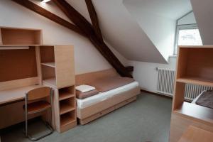 a bedroom with a bed and shelves in a room at Bischöfliches Institut Vinzentinum in Bressanone +21 photos