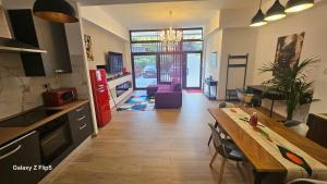a kitchen and living room with a table and a dining room at VIP Lounge in Settimo Milanese