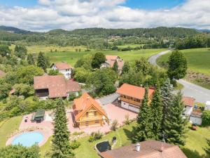 an aerial view of a home with a pool and a house at Holiday Home Chalet Toni mit Sauna by Interhome in Spiegelau
