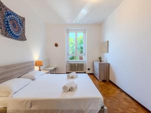 a bedroom with two beds and a window at Apartment Condominio dei Giardini by Interhome in Bellano