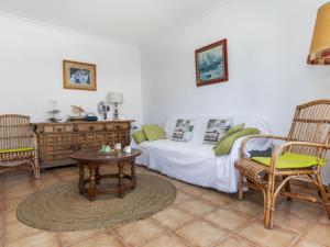 a bedroom with a bed and a table and chairs at Apartment Albaniz by Interhome in Tossa de Mar
