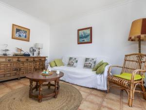 a bedroom with a bed and a table and a chair at Apartment Albaniz by Interhome in Tossa de Mar +12 photos
