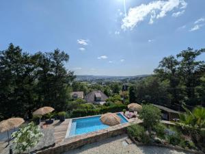 an aerial view of a house with a swimming pool at Brive, La Villa Bellevue in Buissou