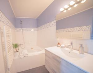 a bathroom with a tub and a sink and a bath tub at Maison du charme Gourdon in Gourdon-en-quercy +26 photos