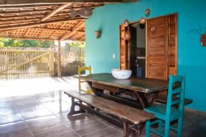 a wooden table and a bench in a room at Casa do Brother in Prado