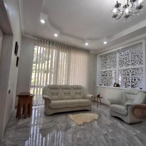 a living room with a couch and two chairs at KEMO house in Batumi +32 photos