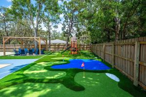 a miniature golf course in a backyard with a playground at 18 Guests Pool Pickleball Volleyball in Seminole