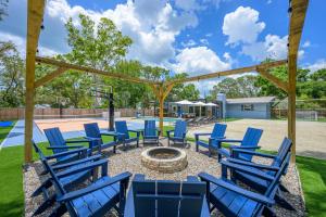 a patio with blue chairs and a fire pit at 18 Guests Pool Pickleball Volleyball in Seminole