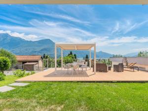 a deck with a gazebo with a table and chairs at Apartment Luccio by Interhome in Consiglio di Rumo