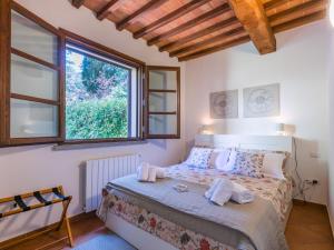 Un dormitorio con una cama y una ventana grande. en Apartment La Casina di Riccardo by Interhome, en Riparbella