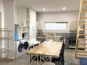 a kitchen with a wooden table and chairs in a kitchen at Grace in Douzy
