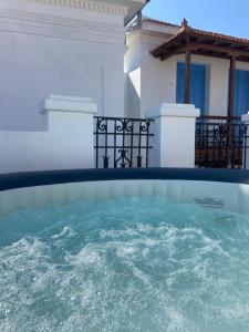 a pool of water in front of a house at Adele house in Skopelos Town