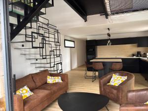a living room with a couch and a table at Gîte des capucines in Plougonvelin