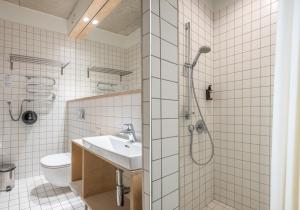 a bathroom with a shower and a sink and a toilet at Melt in Palanga Self check-in in Palanga