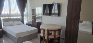 a bedroom with a bed and a stool and a mirror at فندق ميراج باي in Hurghada