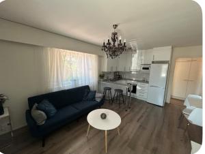 a living room with a couch and a table and a kitchen at Doppingvägen 3 apartment 1 in Mariehamn