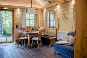 a living room with a table and a blue couch at Hütte Neuhaus in Annaberg im Lammertal +45 photos