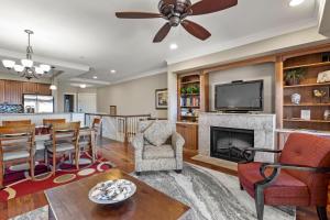 a living room with a fireplace and a tv at Sweet Escape in Kill Devil Hills
