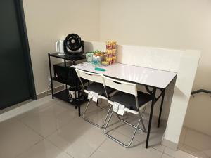 a white desk in a room with a table at Tenang Haven Upper Floor with private porch and staircase in Kajang
