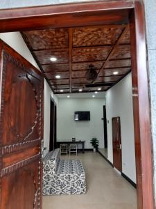 an open door to a room with a table and a television at Dunleigh Apartments Murree in Murree