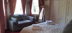 a bedroom with a bed and a chair and a mirror at The Circus Apartment in Bath
