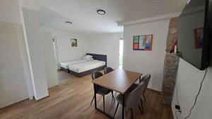 a room with a bed and a table and chairs at Apartma Lana in Koper