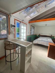 a bedroom with a bed and a table and chairs at Galpón 10 in San Martín de los Andes