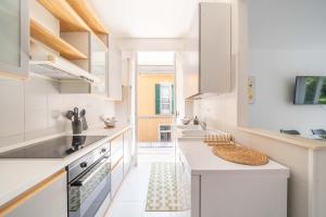 a kitchen with white counters and white appliances at La Darsena Front lake apartment in Maccagno con Pino e Veddasca