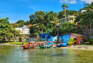 a group of boats are docked on the water at Casa Maré Floripa - Coliving, Coworking & Community in Florianópolis