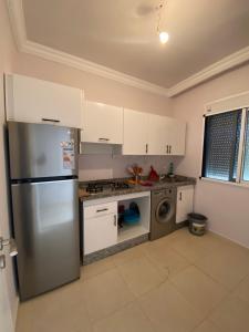 a kitchen with a stainless steel refrigerator and a dishwasher at Appartement à louer Complexe City Center in Oued Laou