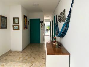 a hallway with a table and a blue door at Hotel CastilloMar in Cartagena de Indias +39 photos