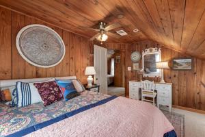 a bedroom with a bed and a wooden ceiling at The Barn in Kill Devil Hills
