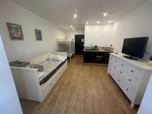 a bedroom with a bed and a dresser with a television at Sublime Sanary plage in Sanary-sur-Mer