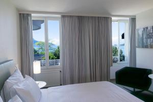 a hotel room with a bed and a window at La Rouvenaz in Montreux