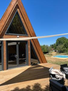 a pyramid house with a deck and a pool at MátraTea Elvonulóház in Parád +49 photos