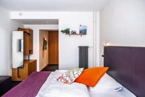 Giường trong phòng chung tại Nomad Design & Lifestyle Hotel