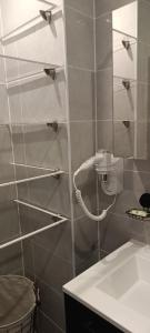 a bathroom with a shower with a phone on the wall at Nice, vue mer et panoramique in Nice +21 photos