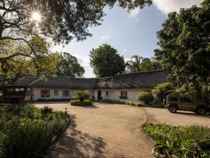 a house with a gambrel roof and a driveway at Seringa Lodge & Safaris in White River