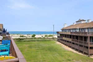 Una vista de la playa desde el balcón de un resort. en The Blue Pelican, en Kitty Hawk