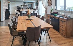 a dining room with a wooden table and chairs at Maison Avec Piscine Vue Mer in Plouhinec