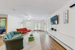 a living room with a couch and a tv at Summertime III in Bar Harbor