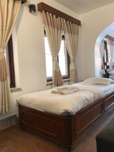 une chambre avec un grand lit avec une grande fenêtre dans l'établissement Apartment in Nepal, à Katmandou 37 autres photos